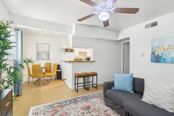 a living room with furniture and wooden floor