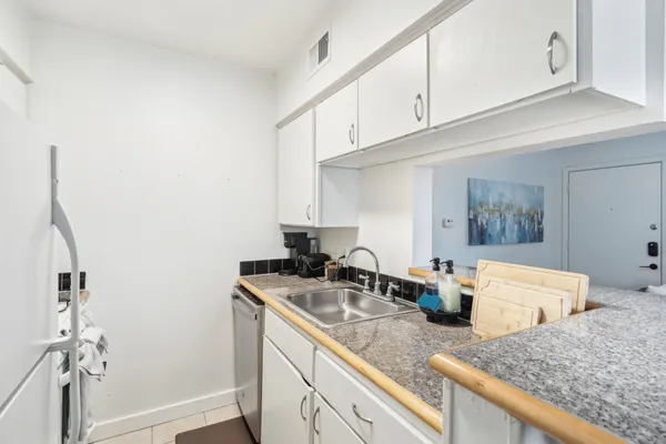 a kitchen with stainless steel appliances granite countertop a sink stove and cabinets