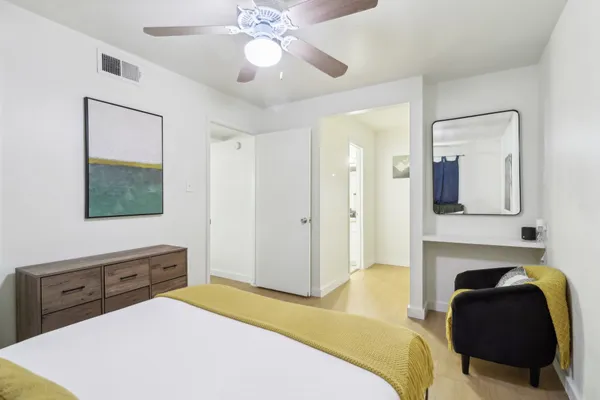 a bedroom with a bed and a chandelier