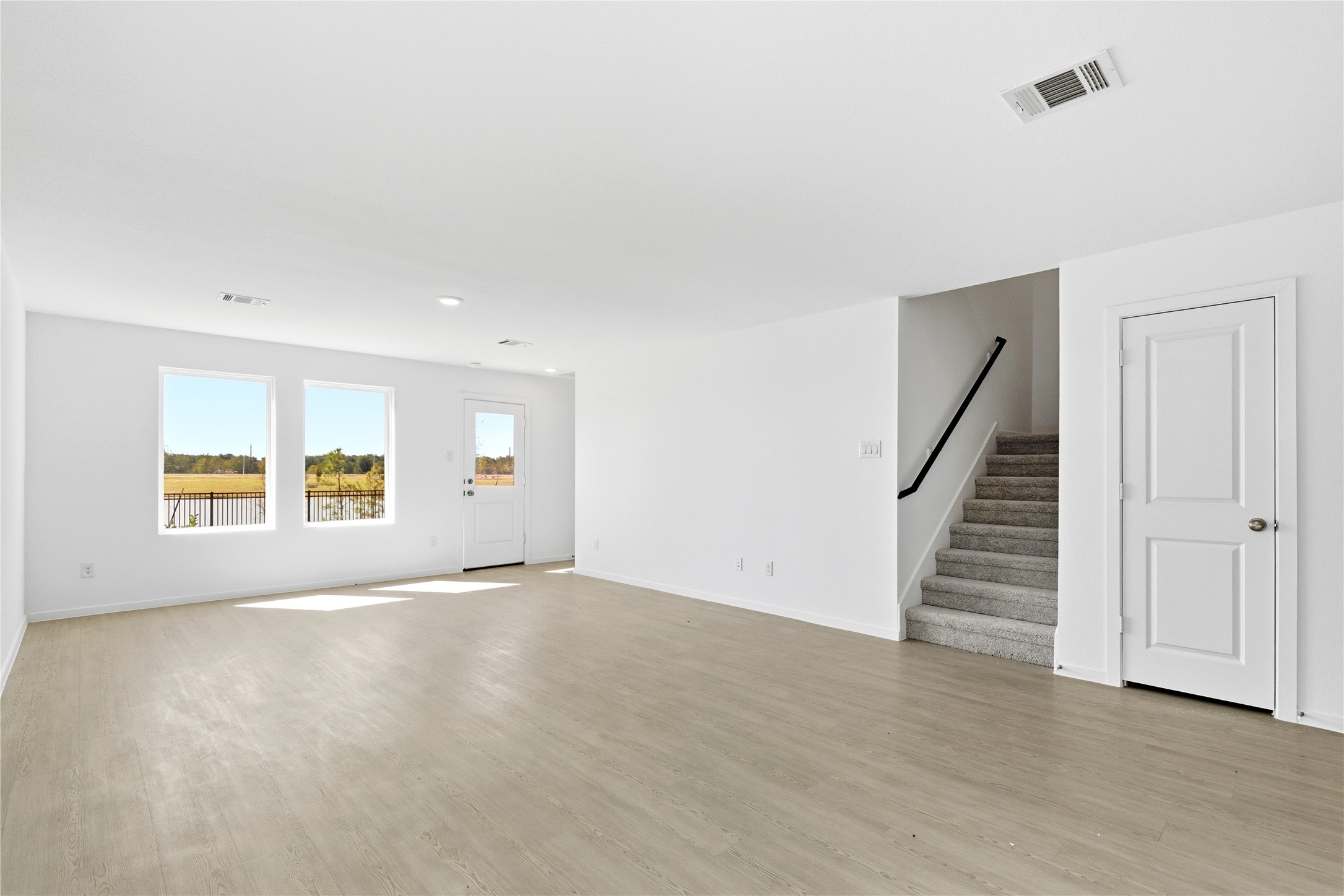 3029 Merganser Ridge Drive Katy, TX 77493 - Photo 8 of 42 a view of an empty room with a window and wooden floor