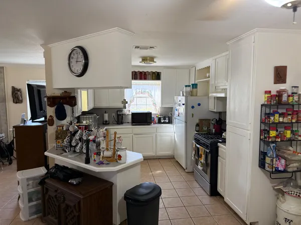 a kitchen with a sink cabinets and appliances