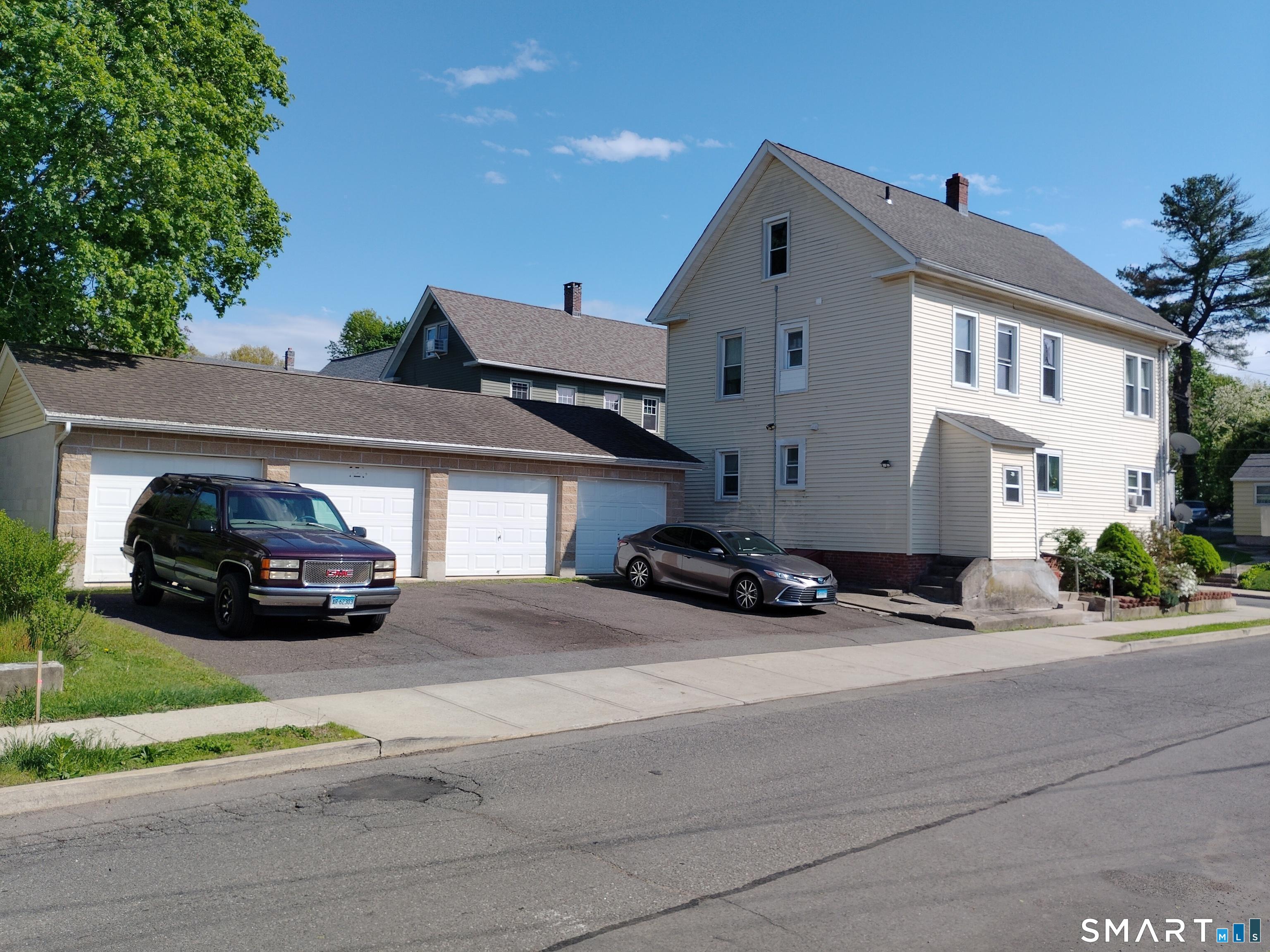 61 Bartlett Street Meriden, CT 06451 - Photo 4 of 30 a car parked in front of a house