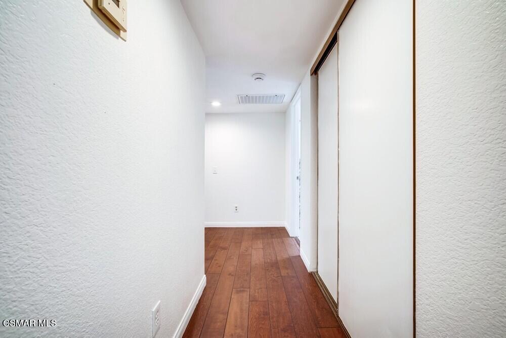 8328 Spring Desert Place, Unit E Rancho Cucamonga, CA 91730 - Photo 10 of 27 a view of a hallway with wooden floor