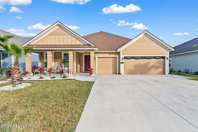 a living room with furniture a window and a potted plant