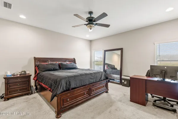 a bedroom with a bed lamp and window