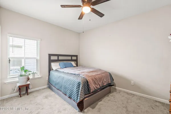 a bathroom with a sink toilet and shower curtain