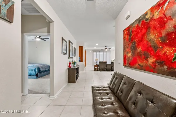 a living room with furniture and a gym cycle