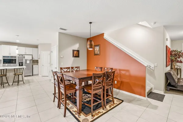 a living room with furniture a window and a potted plant