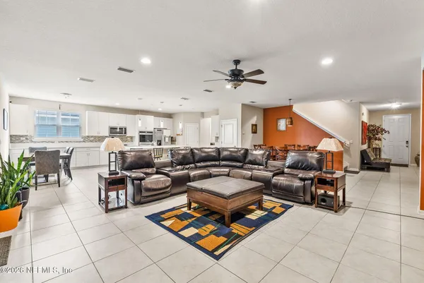 a kitchen with kitchen island white cabinets and stainless steel appliances