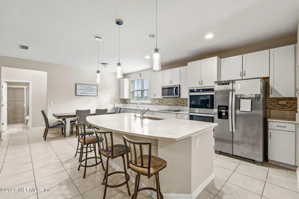 a kitchen with white cabinets