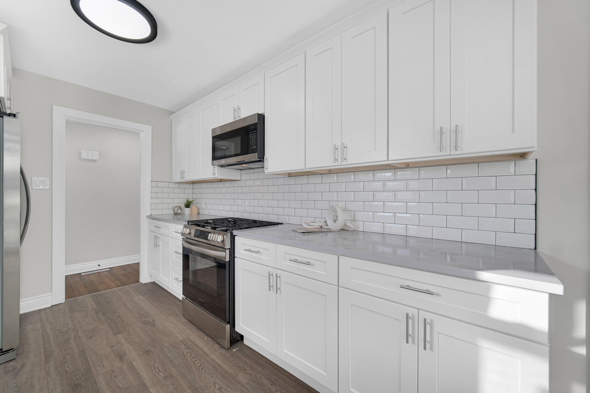 910 High Street Hobart, IN 46342 - Photo 12 of 29 a kitchen with stainless steel appliances granite countertop a stove a sink and white cabinets