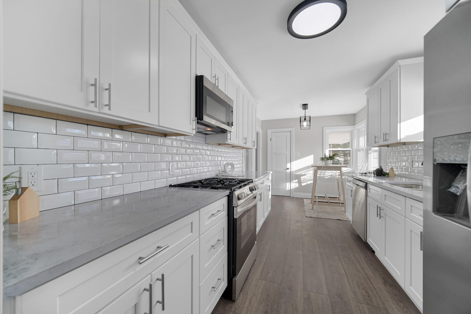 910 High Street Hobart, IN 46342 - Photo 13 of 29 a kitchen with granite countertop a sink a stove oven a counter space and cabinets