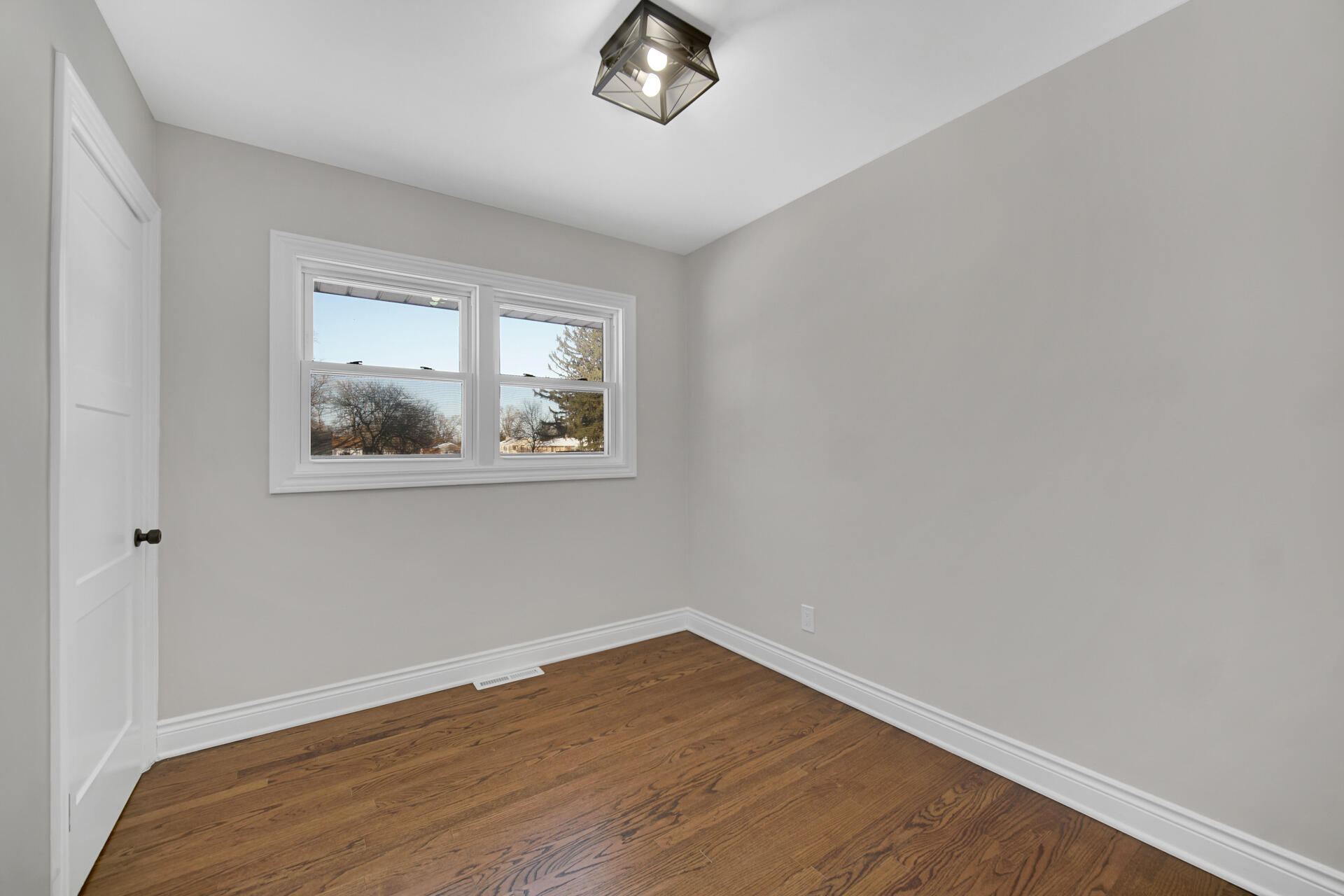 910 High Street Hobart, IN 46342 - Photo 14 of 29 a view of empty room with wooden floor and fan