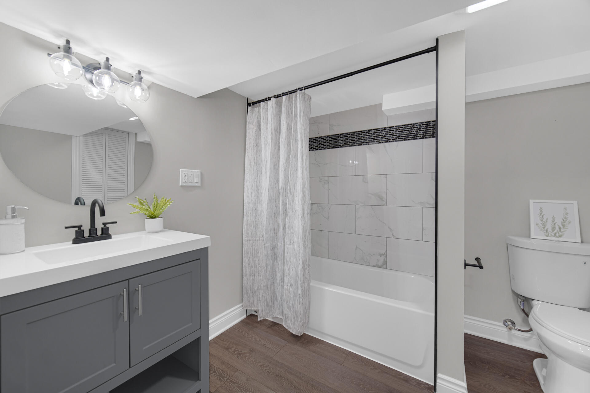 910 High Street Hobart, IN 46342 - Photo 24 of 29 a bathroom with a bathtub shower sink vanity and toilet