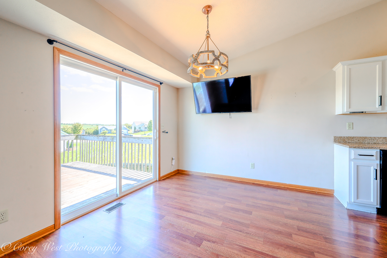 8453 Crooked Bend Road Machesney Park, IL 61115 - Photo 11 of 27 a view of a big room with wooden floor and windows