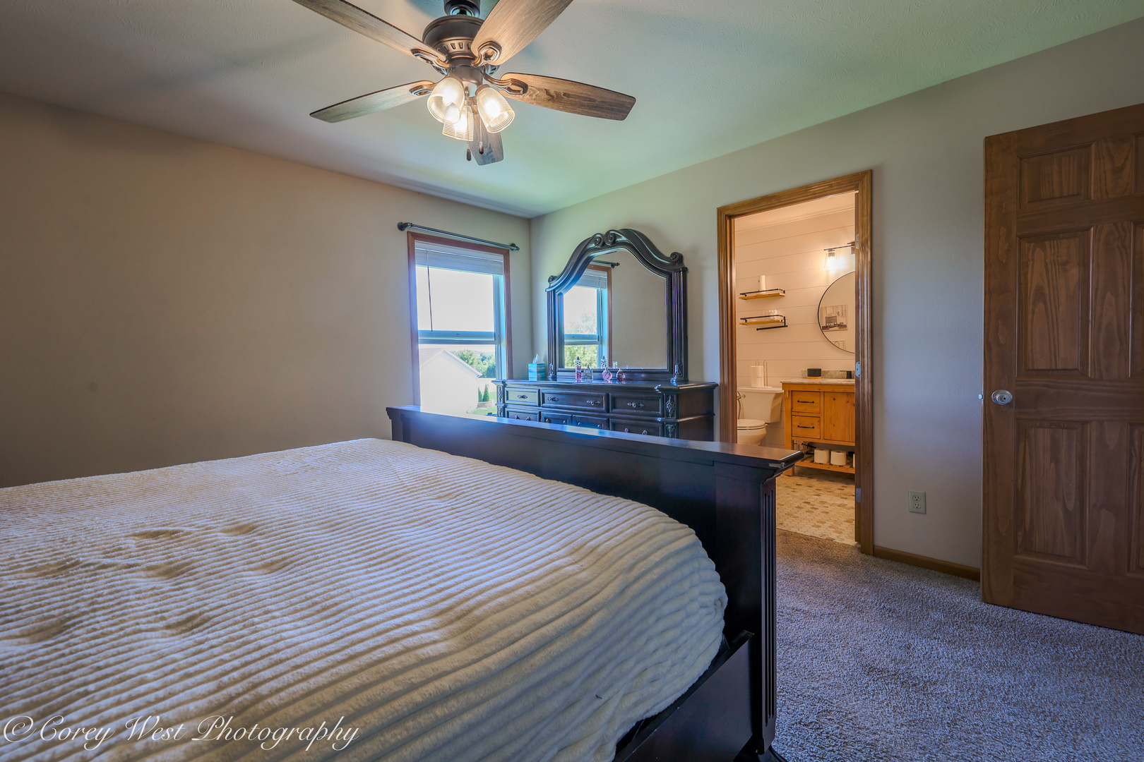 8453 Crooked Bend Road Machesney Park, IL 61115 - Photo 14 of 27 a bedroom with a bed and a chandelier