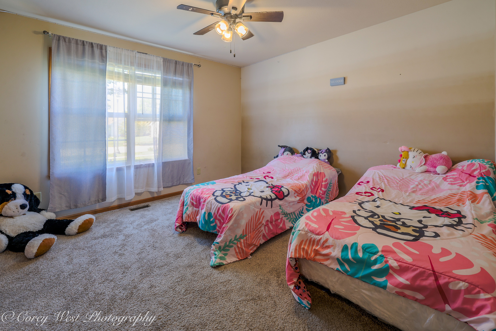 8453 Crooked Bend Road Machesney Park, IL 61115 - Photo 19 of 27 a bedroom with two beds and a chandelier