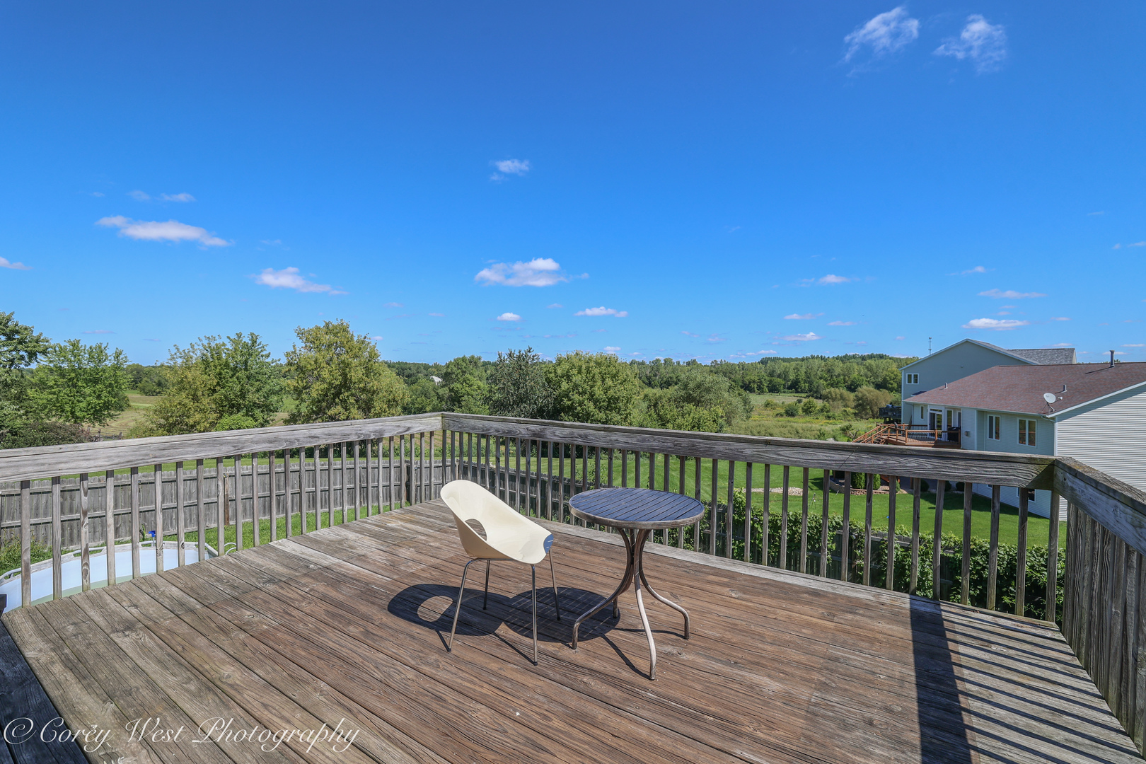 8453 Crooked Bend Road Machesney Park, IL 61115 - Photo 24 of 27 a view of a balcony with wooden floor and outdoor seating