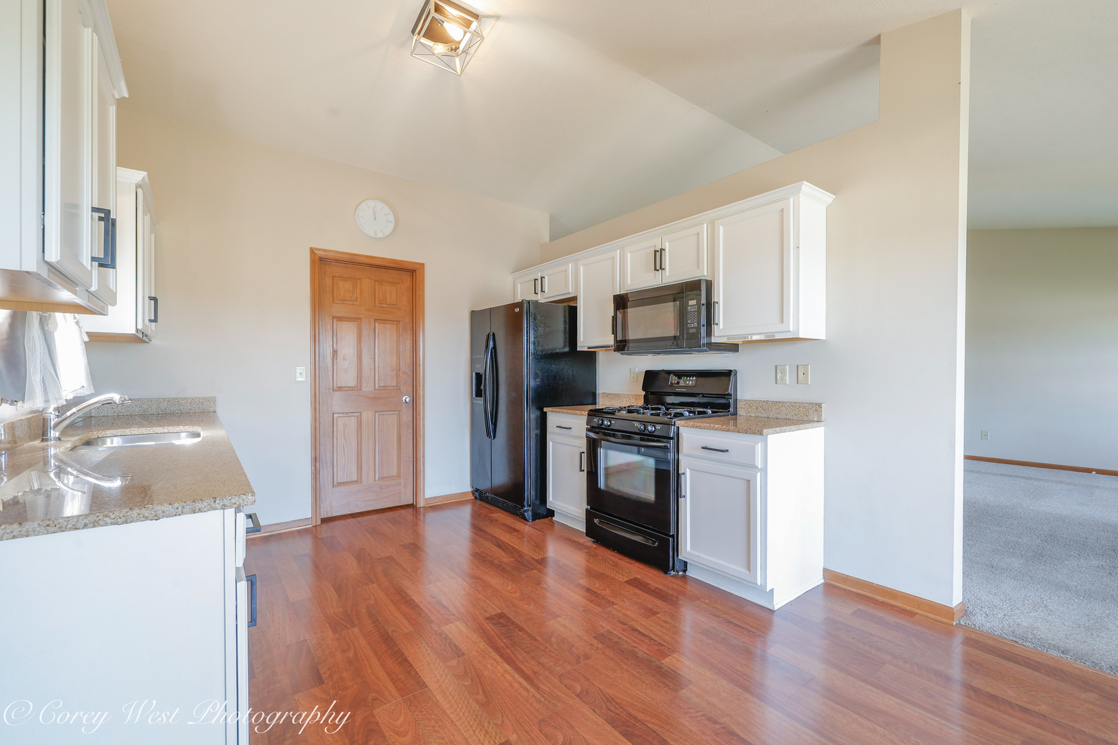 8453 Crooked Bend Road Machesney Park, IL 61115 - Photo 8 of 27 a kitchen with granite countertop a refrigerator stove top oven and sink