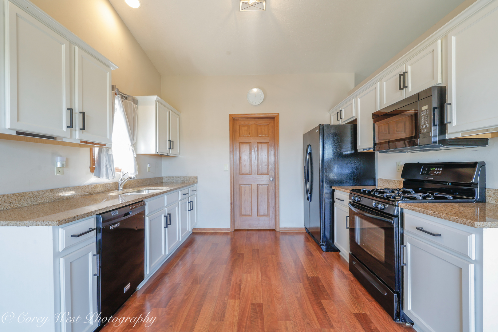 8453 Crooked Bend Road Machesney Park, IL 61115 - Photo 9 of 27 a kitchen with stainless steel appliances granite countertop hardwood floor sink stove and wooden cabinets