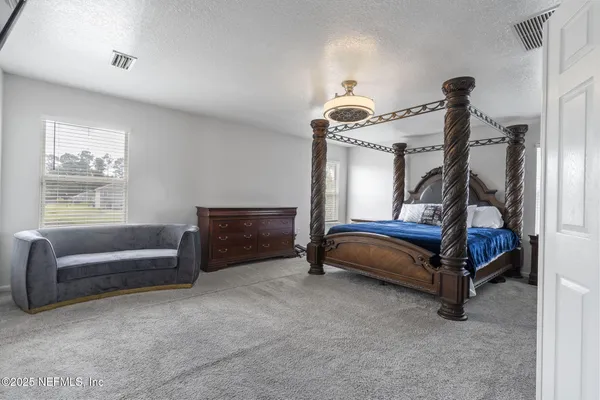 a bedroom with furniture and a window