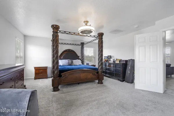 a bedroom with a bed and a ceiling fan