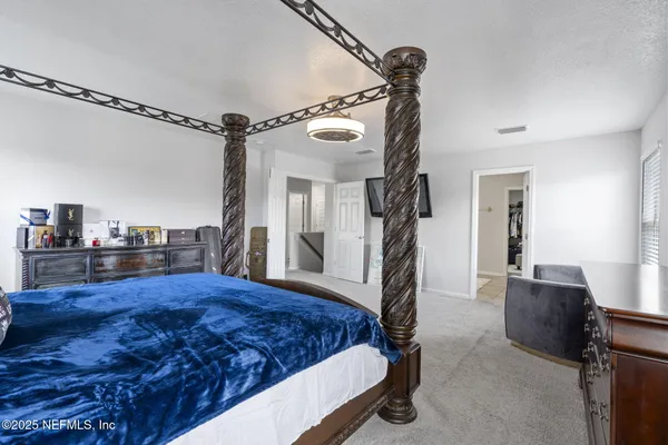 a bed room with a bed and a chandelier