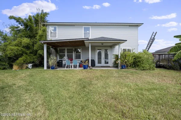 a view of a house with a porch and furniture