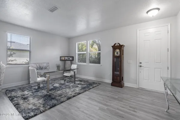 a living room with furniture a window and a table