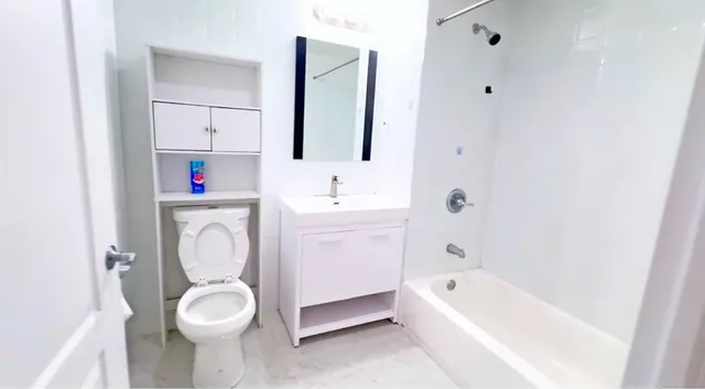 a bathroom with a sink toilet and bathtub