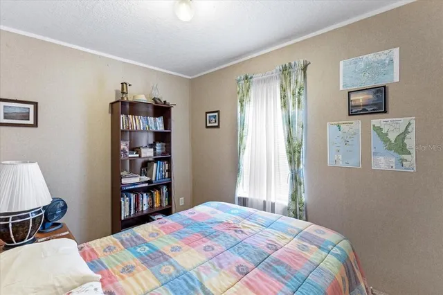 a bedroom with a bed and a book shelf