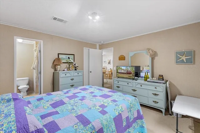 a bedroom with a bed and a dresser in it