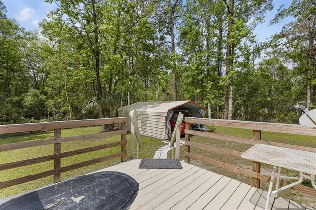 a view of a roof deck with wooden floor and fence