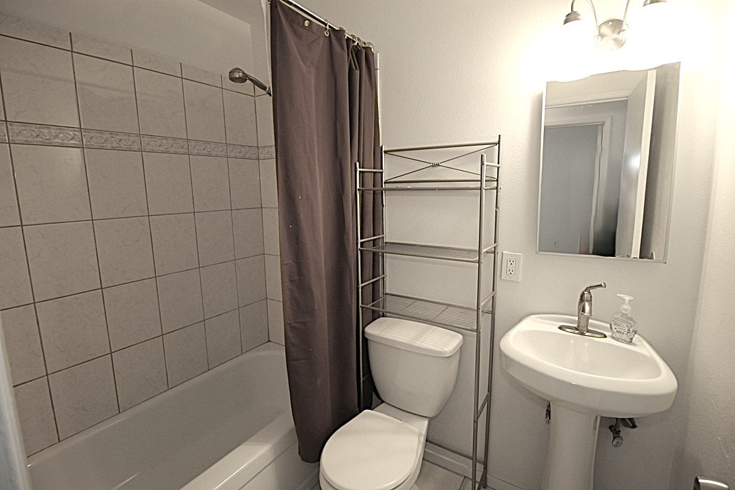 308 Muir Street Barstow, CA 92311 - Photo 14 of 27 a bathroom with a sink toilet and shower
