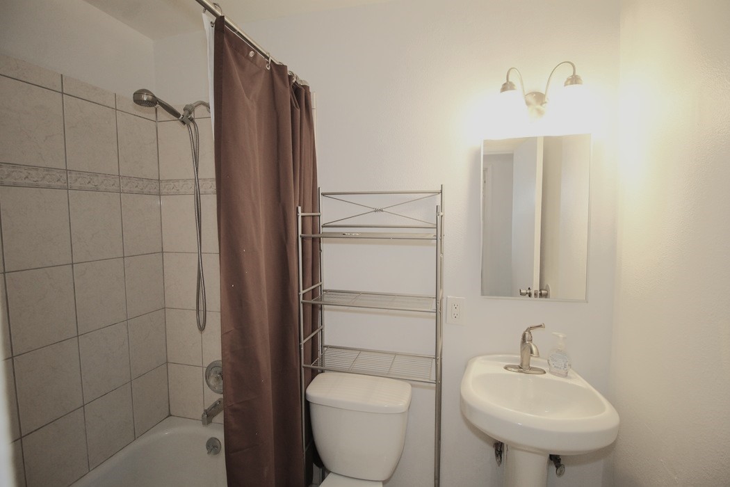308 Muir Street Barstow, CA 92311 - Photo 15 of 27 a bathroom with a toilet sink and shower