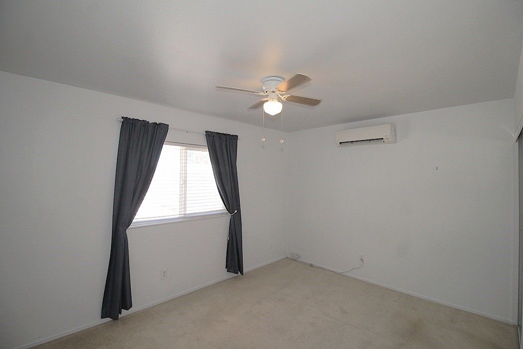 308 Muir Street Barstow, CA 92311 - Photo 17 of 27 an empty room with a window and a fan