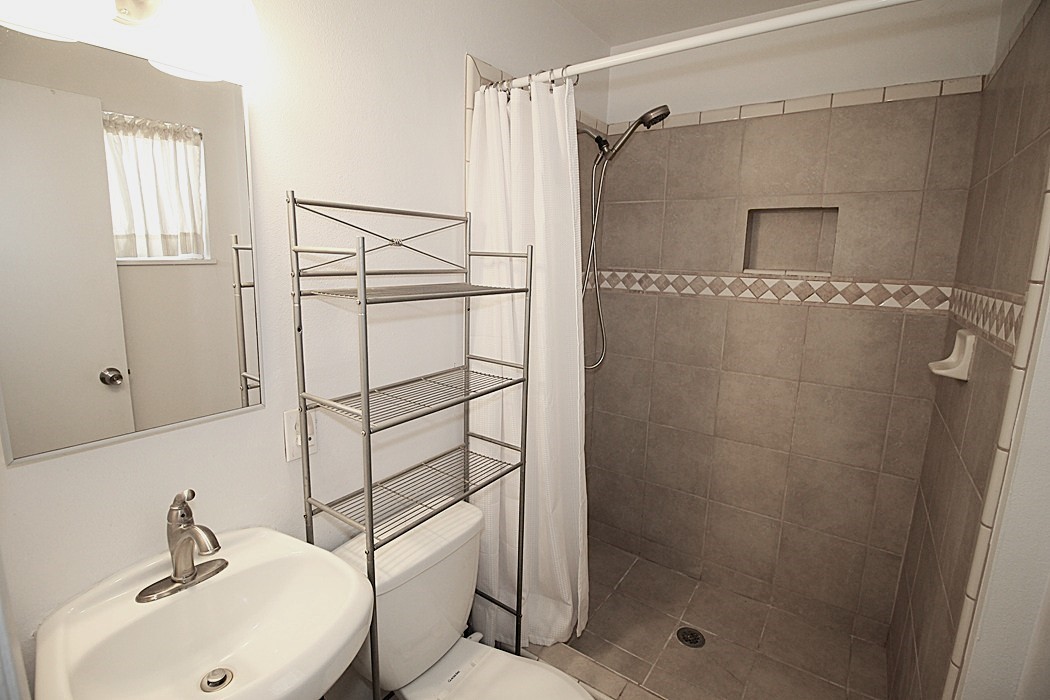 308 Muir Street Barstow, CA 92311 - Photo 19 of 27 a bathroom with a shower and a sink