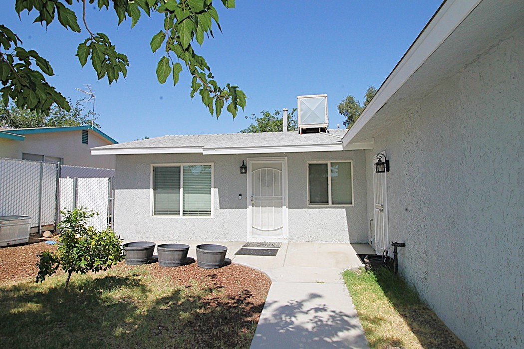 308 Muir Street Barstow, CA 92311 - Photo 3 of 27 a front view of a house with a yard