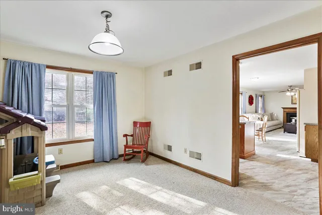 a view of a livingroom with furniture and a window