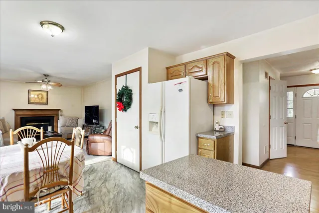 a living room with furniture a dining table and wooden floor