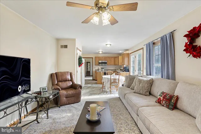 a living room with furniture and a flat screen tv with wooden floor