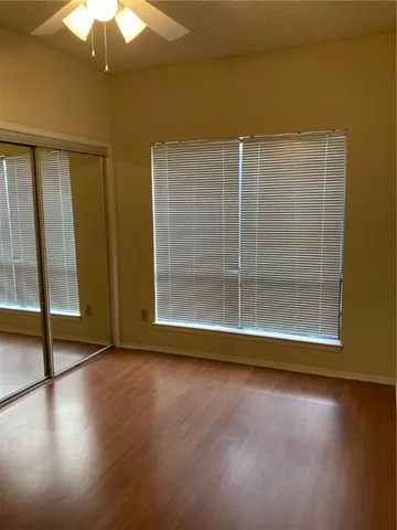 a view of a livingroom with wooden floor and a ceiling fan