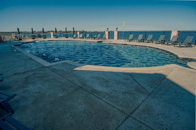 a view of a swimming pool with a yard
