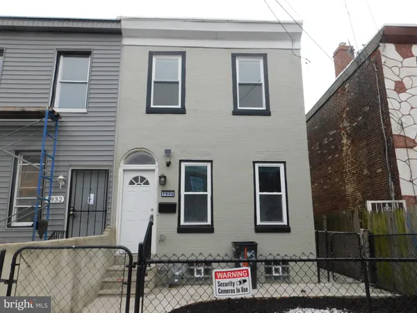 a front view of a house with many windows