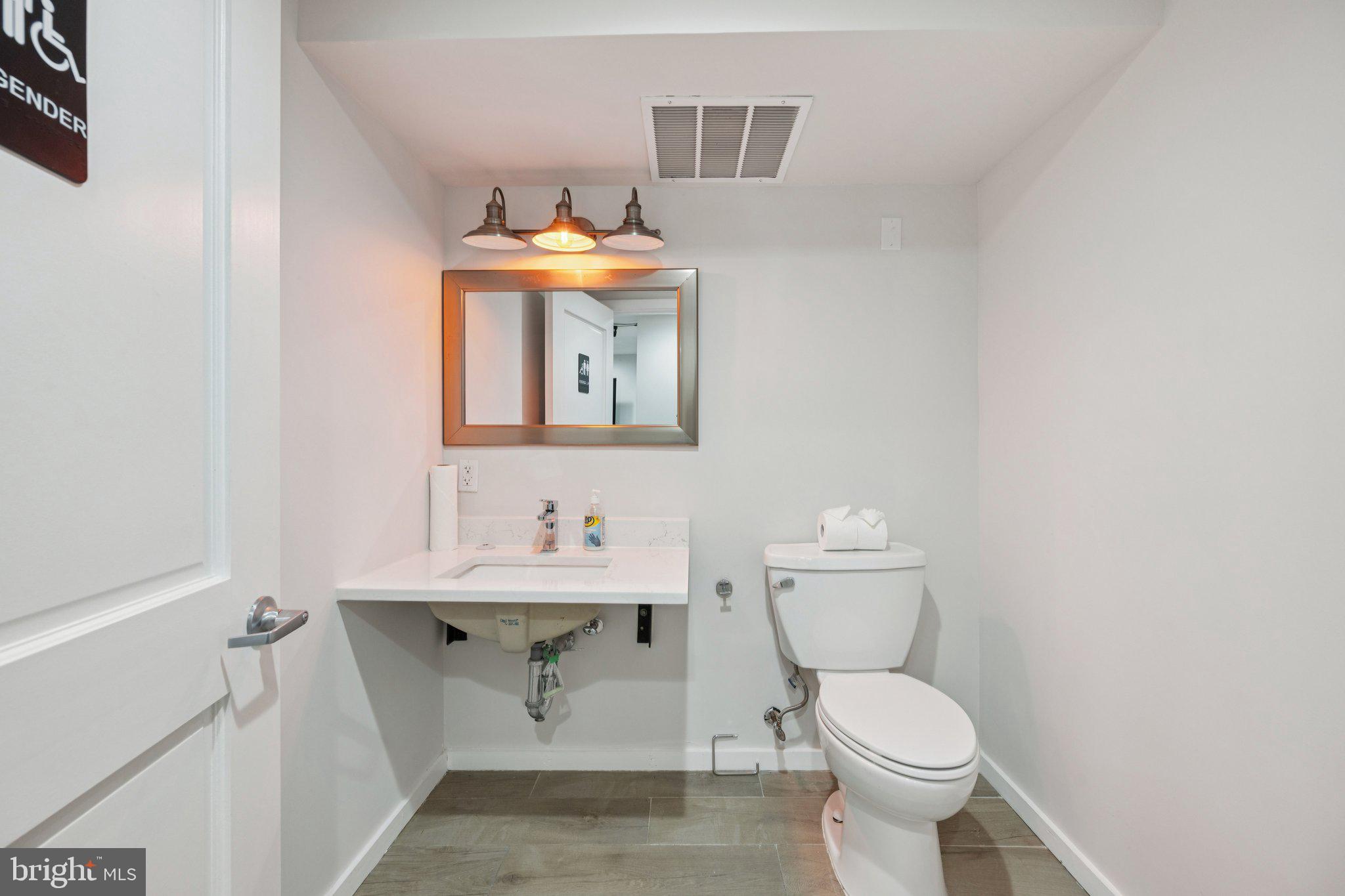 2708 Ontario Road Northwest Washington, DC 20009 - Photo 11 of 31 a bathroom with a toilet sink and mirror