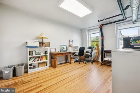 a room with a bed and a book shelf