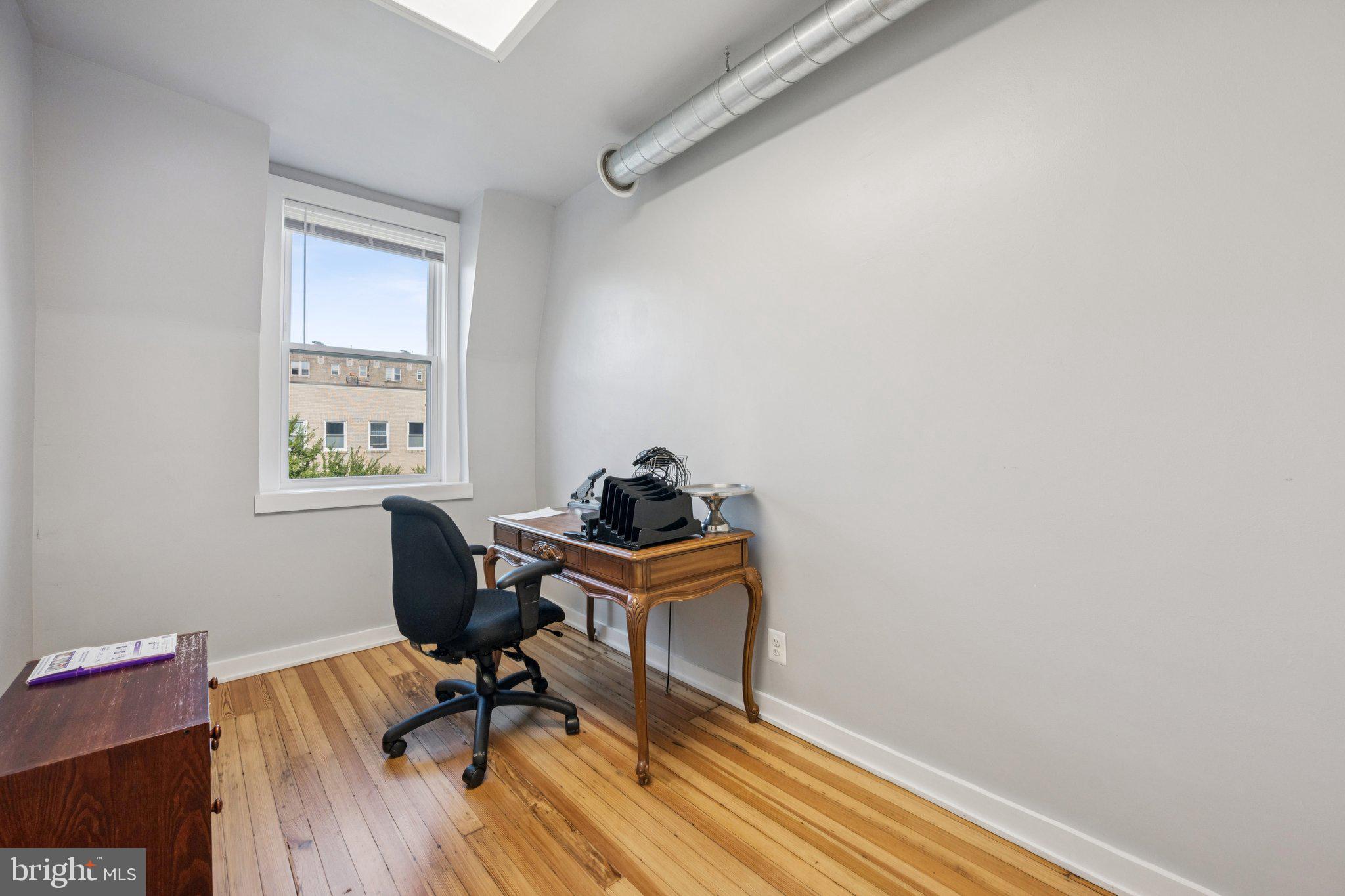2708 Ontario Road Northwest Washington, DC 20009 - Photo 14 of 31 a view of a workspace with furniture and wooden floor