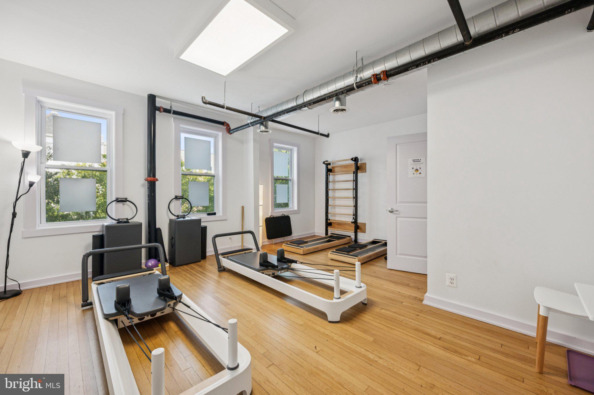 2708 Ontario Road Northwest Washington, DC 20009 - Photo 17 of 31 a living room with furniture gym equipment and a large window
