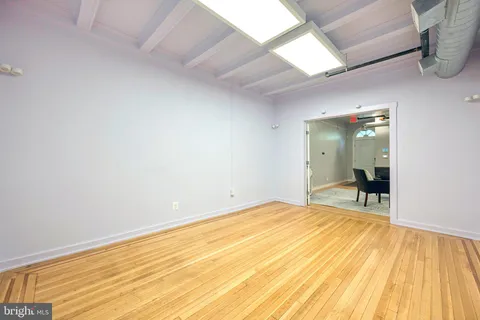 a view of a room with wooden floor and a sink