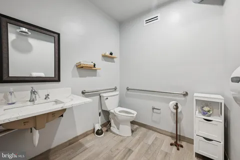 a bathroom with a toilet sink and mirror